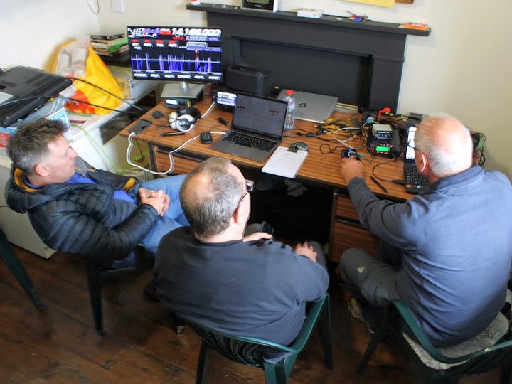 Club members monitoring activity at the operating desk.