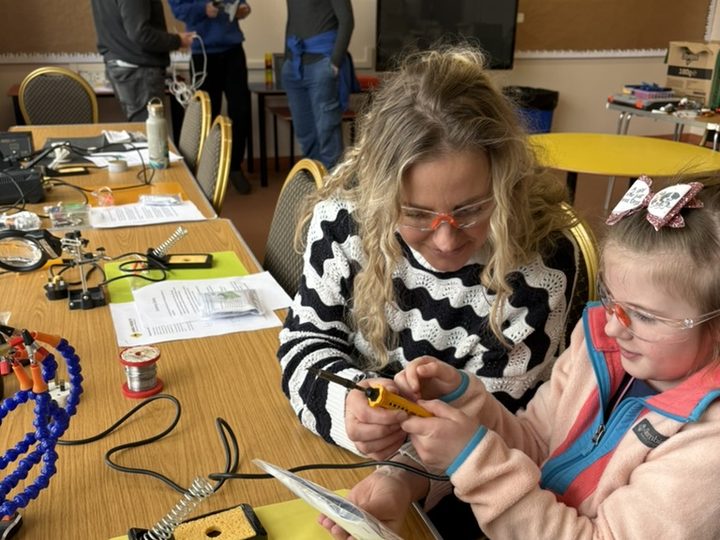 Learning practical soldering skills together.