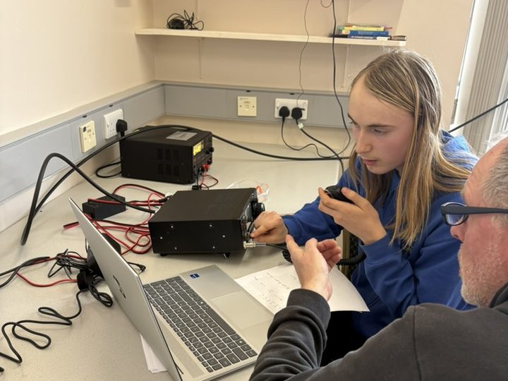 Getting hands-on experience operating an amateur radio.